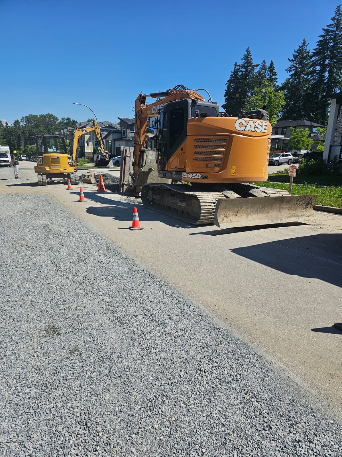 Excellence Excavating branded dump truck and excavator on site