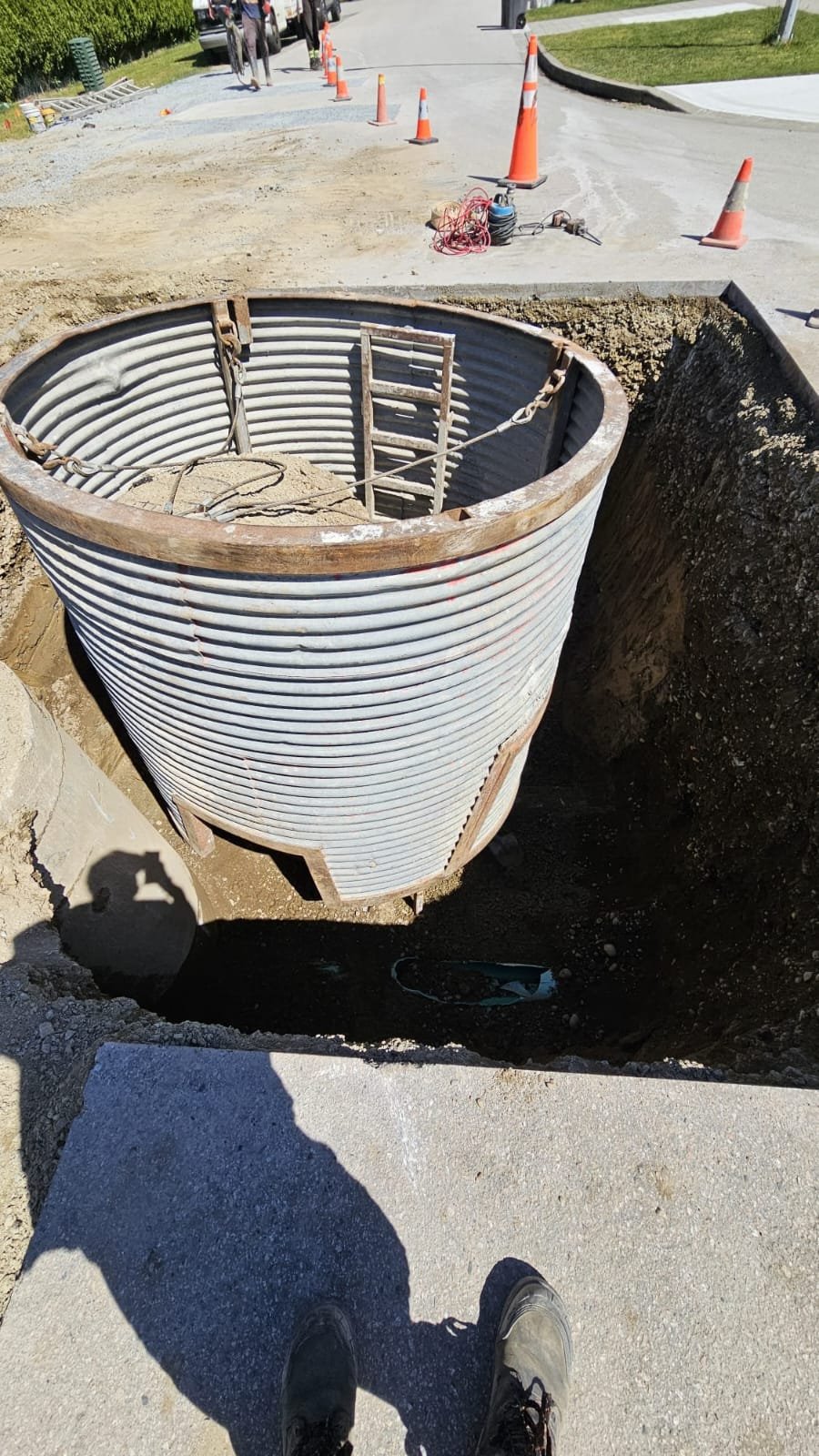 Corrugated manhole sleeve set in deep excavation